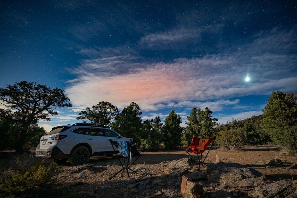 Campsite under a starry, moonlit sky