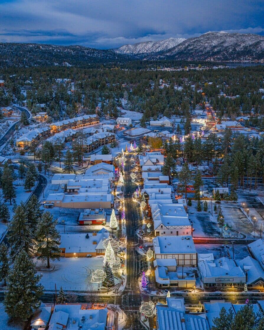 Aerial view of the Village dusted with snow and lit for the holidays