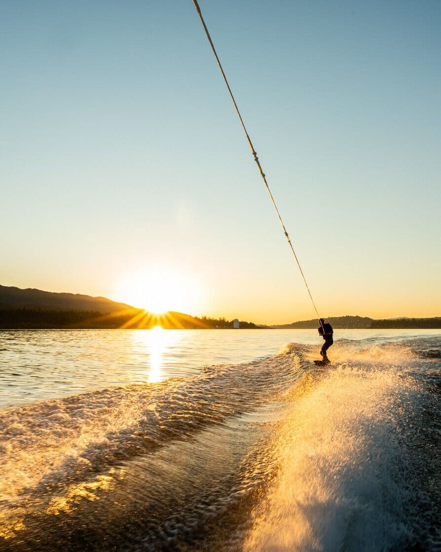 Wakeboarder on the lake at sunset